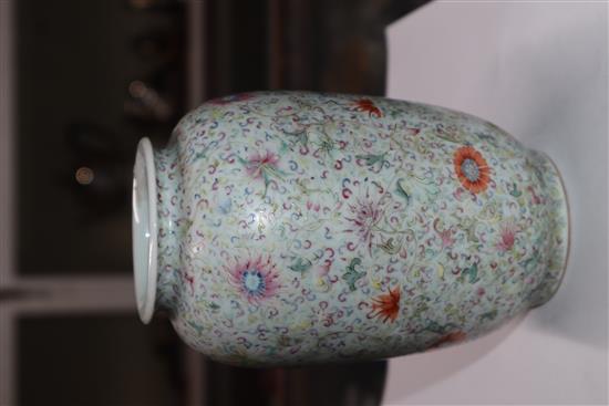 A Chinese famille rose ovoid vase, Qing dynasty, finely painted with flowers and scrolling foliage, H. 15cm, drilled hole to side of ba